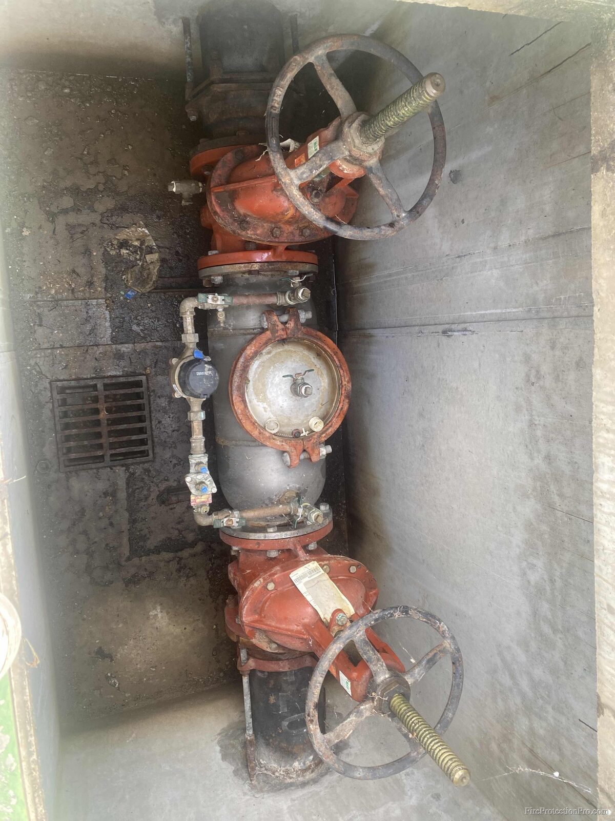 RPZ backflow assembly in below-grade vault with OS&Y gate valves and test cocks