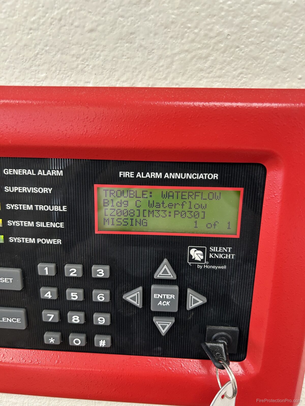 Silent Knight fire alarm annunciator displaying TROUBLE: WATERFLOW signal with zone and point details