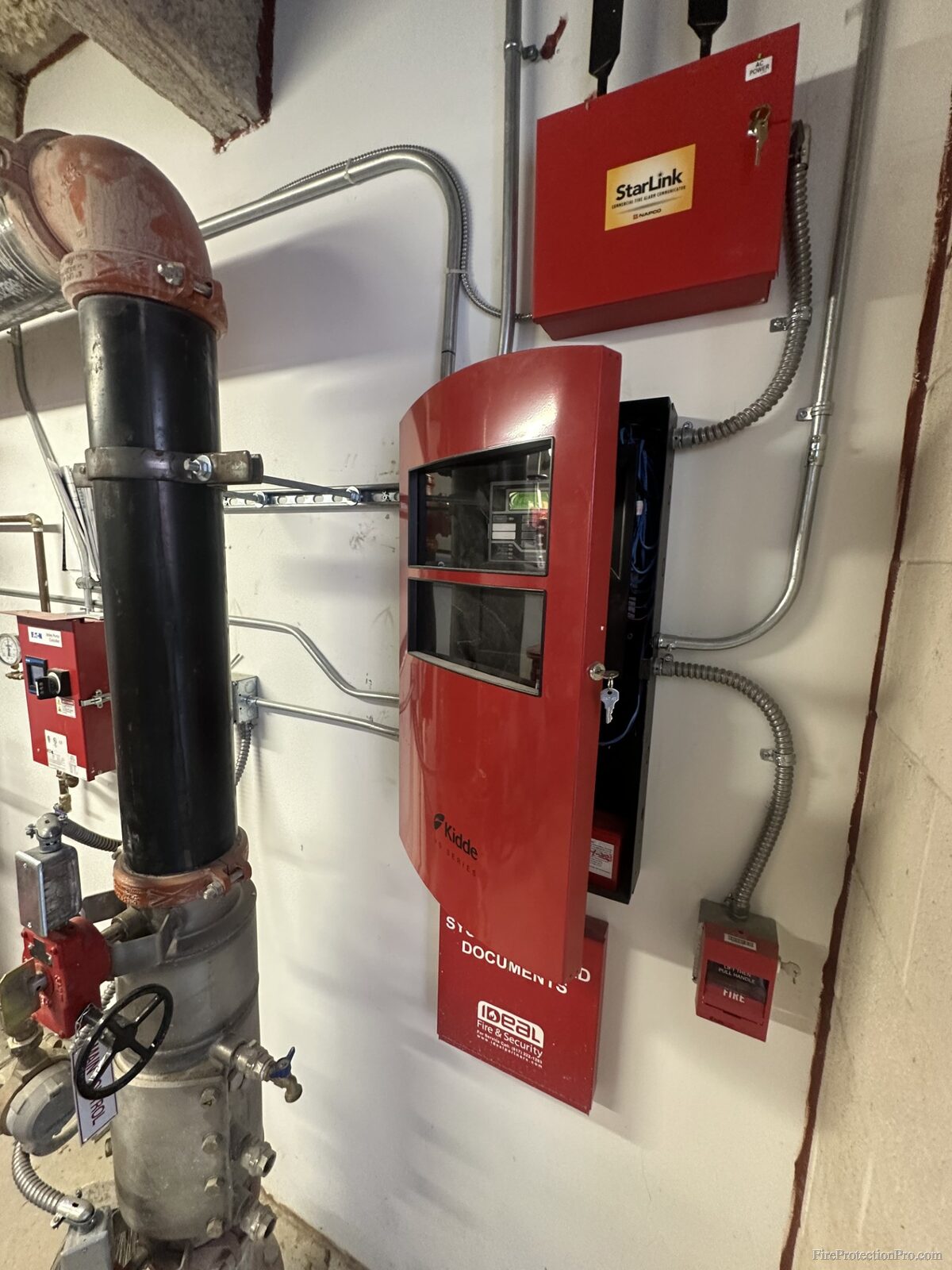 Fire alarm panel room showing control panel, OS&Y valve, and manual pull station