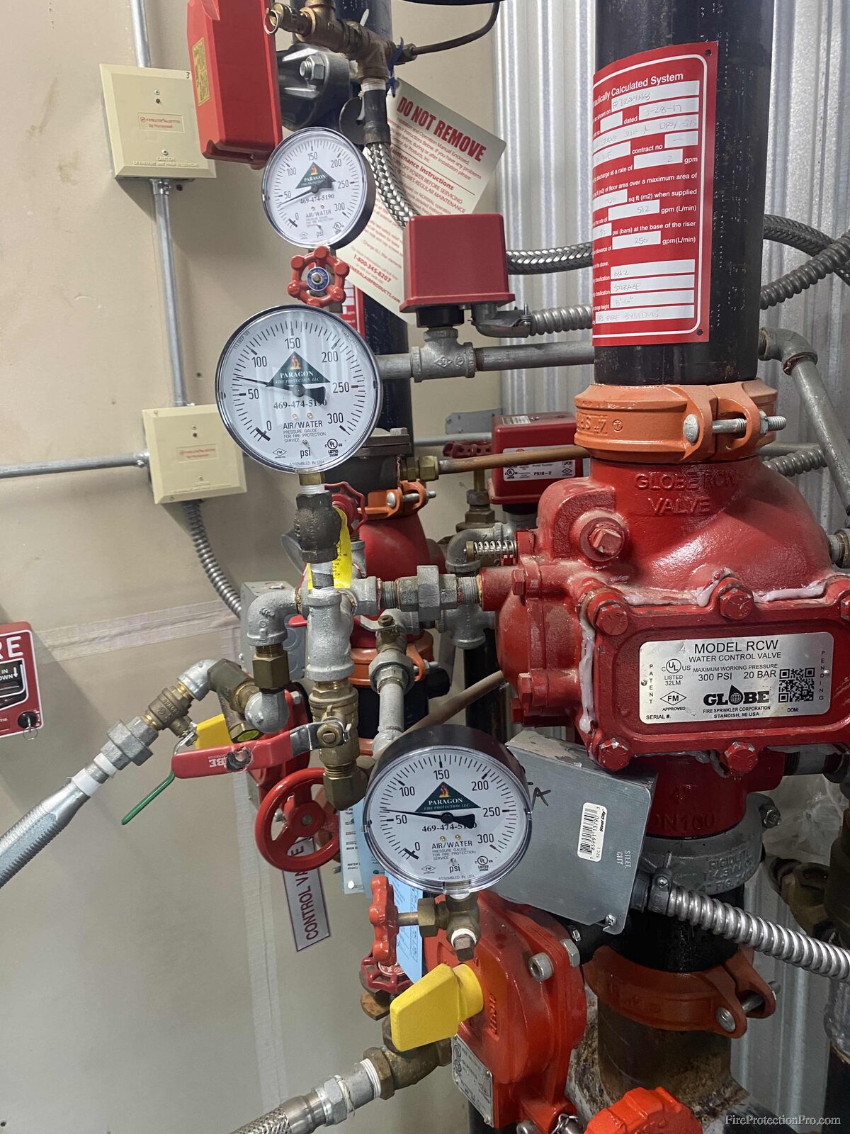 Alarm check valve with system and supply pressure gauges on sprinkler riser