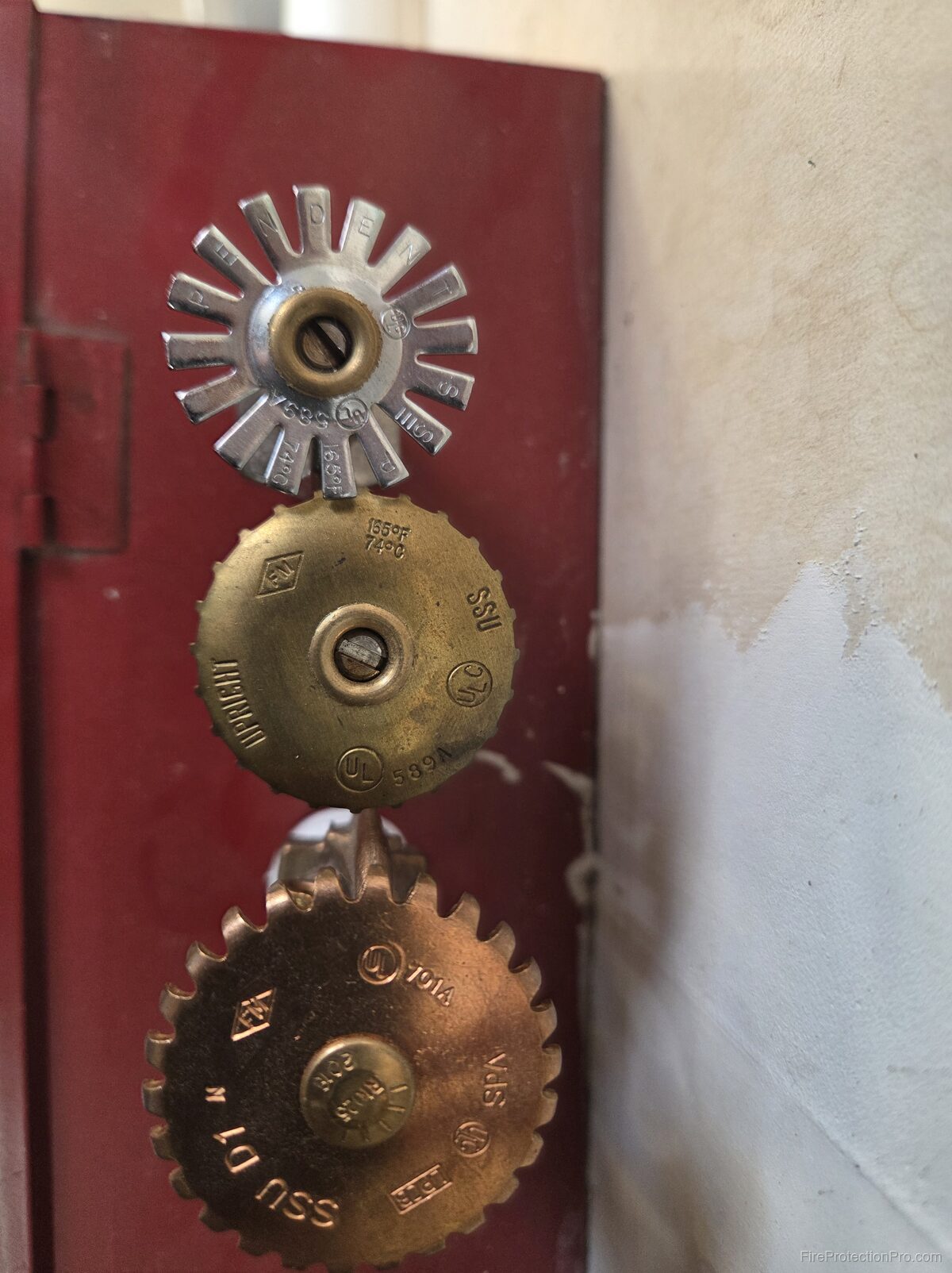 Top-down view of sprinkler head deflectors showing UL and FM certification markings